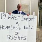 TJ Beers holds a sign to advocate for the rights of people experiencing homelessness outside the state Capitol on April 9. Beers was homeless for four years and in three states. I dont know how I survived, he said. (Claire Stremple/Alaska Beacon)