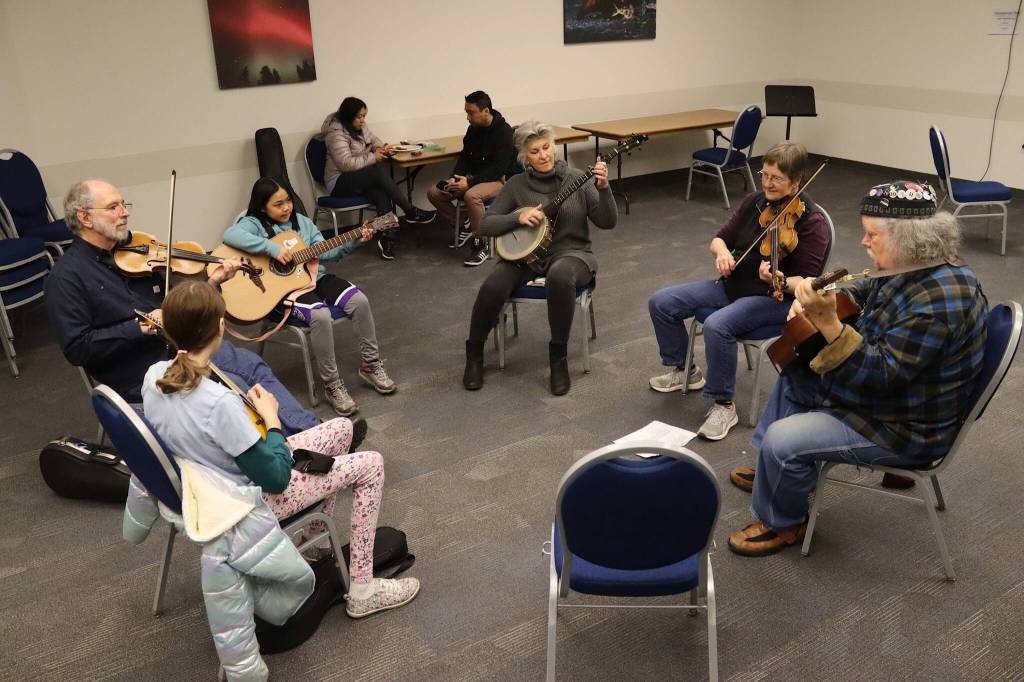 John Hatton, right, leads a Crooked Tunes For All Instruments workshop in the Hickel Room at Centennial Hall as part of the Alaska Folk Festival on Sunday. (Mark Sabbatini / Juneau Empire)