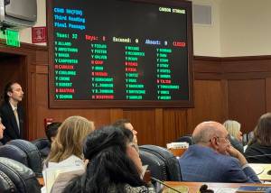 Members of the Alaska House of Representatives watch as votes are tallied on House Bill 50, the carbon storage legislation, on Wednesday. (James Brooks/Alaska Beacon)