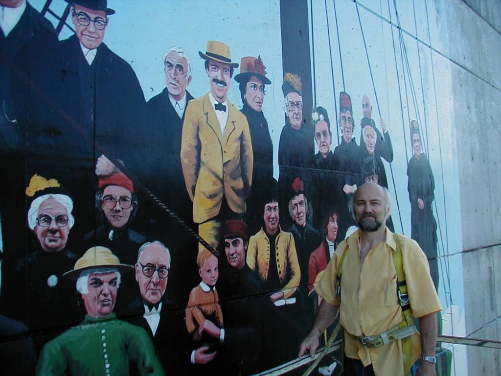 Artist Dan DeRoux inspects his mural several years after it was painted. (Photo courtesy Dan DeRoux)