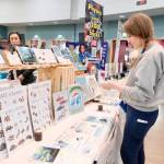 Danielle Brubaker shops for homeschool materials at the IDEA Homeschool Curriculum Fair in Anchorage on Thursday. A court ruling struck down the part of Alaska law that allows correspondence school families to receive money for such purchases. (Claire Stremple/Alaska Beacon)