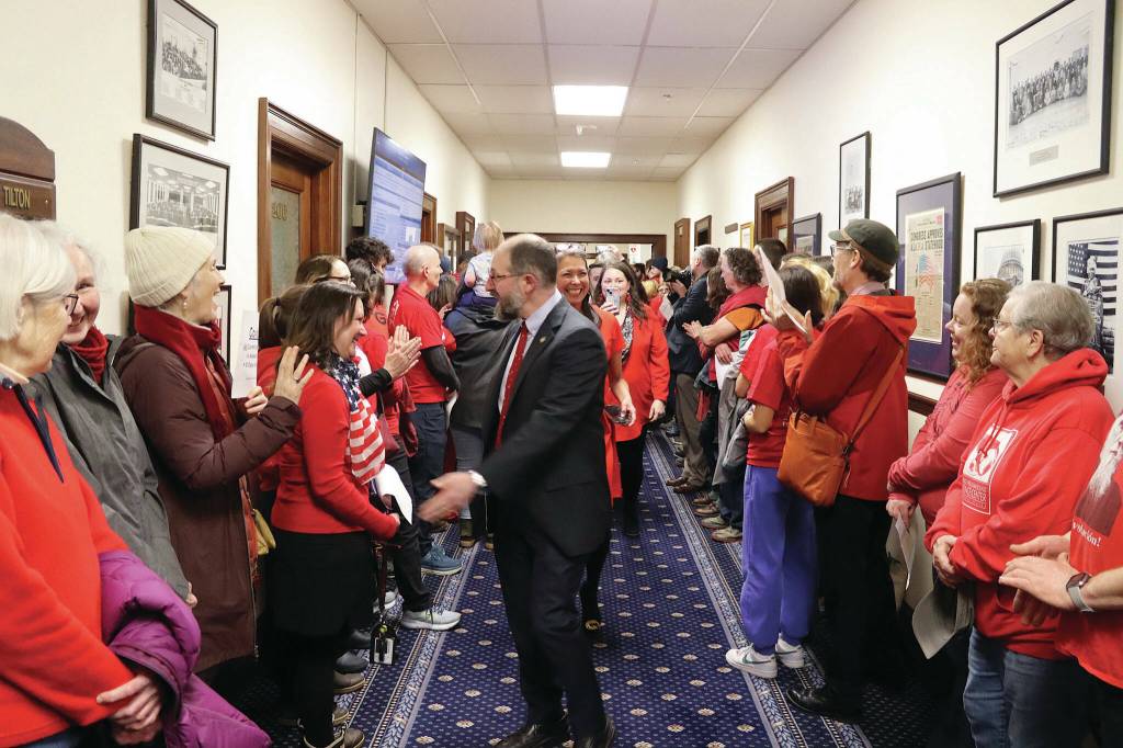 State Sen. Jesse Kiehl, a Juneau Democrat, greets educators and other people rallying in a hallway of the Alaska State Capitol just before the Legislatures override vote on Senate Bill 140 on Monday, March 18, 2024. (Mark Sabbatini / Juneau Empire file photo)