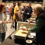 Willis Kirkpatrick serves soup to Jamie Quinto during the Empty Bowls fundraiser on behalf of the Glory Hall at Centennial Hall on Sunday. (Mark Sabbatini / Juneau Empire)