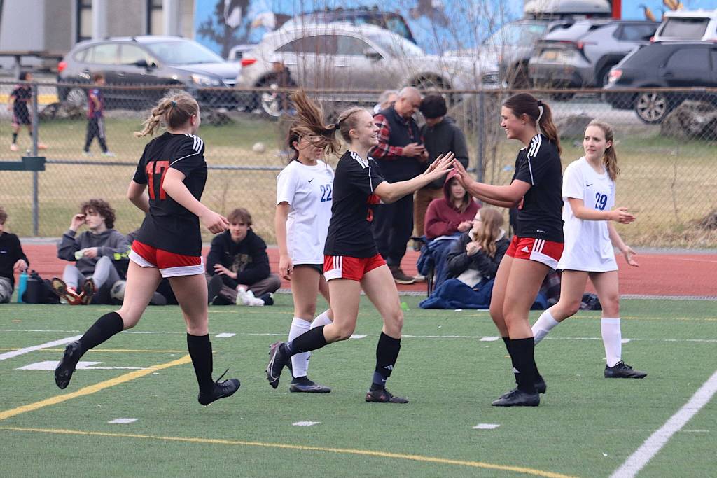 Juneau-Douglas High School: Yadaa.at Kalés Peyton Wheeler (#5) is congratulated after scoring a goal during the second half of Mondays game against Thunder Mountain High School at Adair-Kennedy Field. (Mark Sabbatini / Juneau Empire)