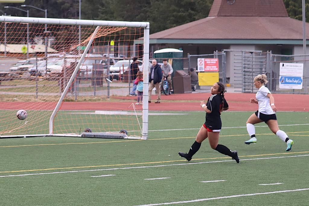 Milina Mazon scores one of her three goals for Juneau-Douglas High School: Yadaa.at Kalé during Mondays game against Thunder Mountain High School at Adair-Kennedy Field. (Mark Sabbatini / Juneau Empire)
