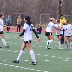 Miley Andrews (#16) is congratulated by teammates after scoring a goal on a free kick for Thunder Mountain High School during Mondays game against Juneau-Douglas High School: Yadaa.at Kalé at Adair-Kennedy Field. (Mark Sabbatini / Juneau Empire)