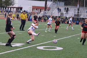 Clairee Overson (#8) kicks the ball downfield for Thunder Mountain High School during Mondays game against Juneau-Douglas High School: Yadaa.at Kalé at Adair-Kennedy Field. (Mark Sabbatini / Juneau Empire)