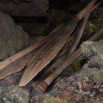 Kayak paddles and a spear tipped with a sharpened rock lie in a volcanic cave on the Seward Peninsula in 2010. (Photo by Ben Jones)