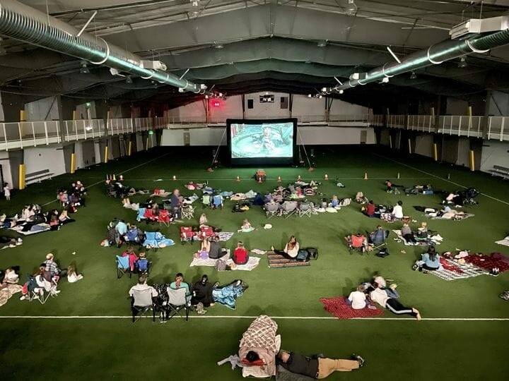 People watch a movie at the Dimond Park Field House. (City and Borough of Juneau photo)