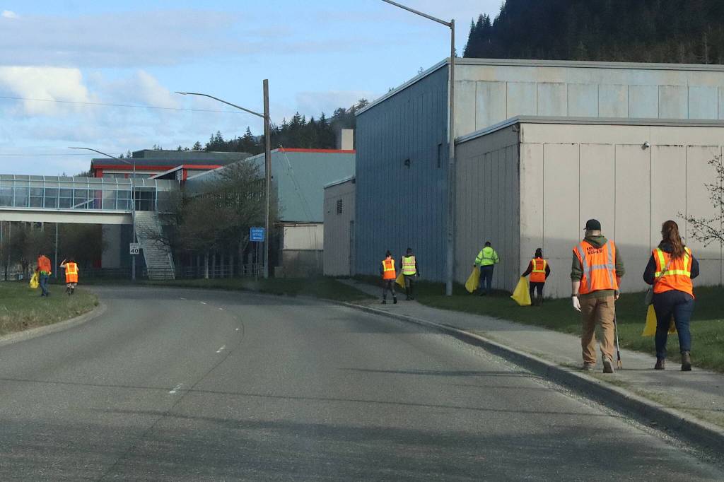 Members of the International Brotherhood of Electrical Workers Local 1547 pick up trash along Egan Drive during the annual Litter Free community cleanup on Saturday morning. (Mark Sabbatini / Juneau Empire)