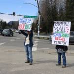 Shannan Greene (left) and Sharyn Augustine hold signs on Saturday urging residents to sign recall petitions for Juneau Board of Education President Deedie Sorensen and Vice President Emil Mackey due to their roles in a budget crisis for the current fiscal year. The effort was launched about three weeks ago and petitioners have 60 days to gather enough signatures to put the recall of one or both board members on the ballot. (Mark Sabbatini / Juneau Empire)