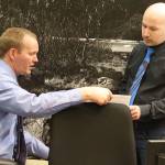 Juneau Assembly member Paul Kelly (right) discusses legal options with City Attorney Robert Palmer during a break in a meeting Monday where a resolution Kelly introduced calling for a bilateral peace agreement in Israel and Palestine was debated. (Mark Sabbatini / Juneau Empire)