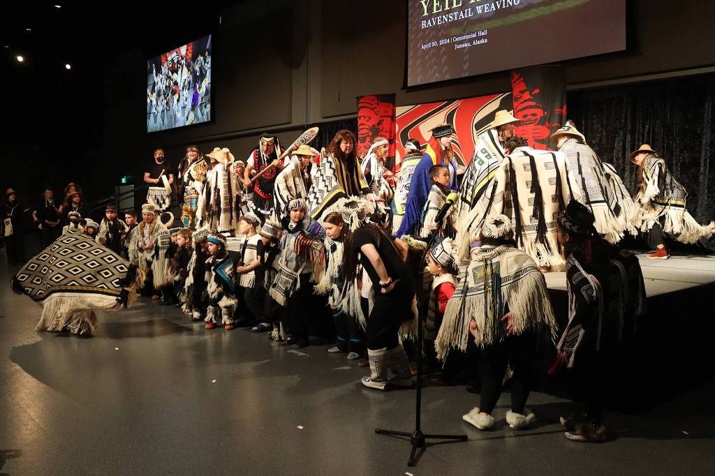 About 50 child and adult dancers participate in what an organizer called the largest-ever gathering of Ravenstail regalia during a ceremony Tuesday evening at Centennial Hall. (Mark Sabbatini / Juneau Empire)