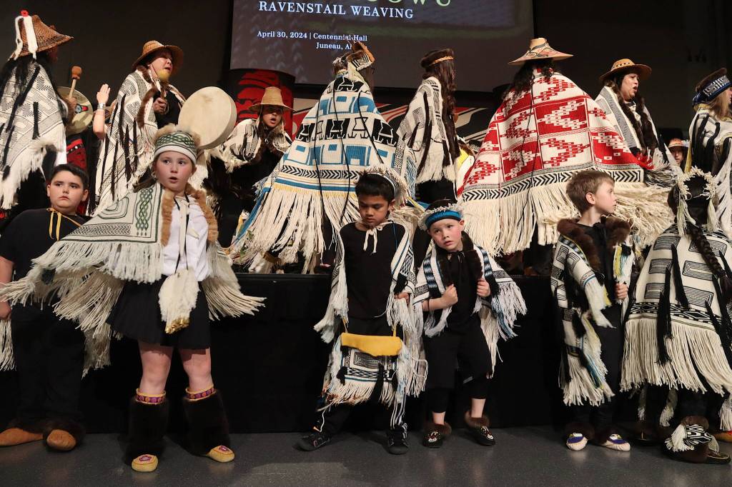About 50 child and adult dancers participate in what organizers called the largest-ever assembly of new Ravenstail weavings during a ceremony Tuesday evening at Centennial Hall. (Mark Sabbatini / Juneau Empire)