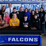 James Polasky, left, and Samuel Lockhart, right, pose with their families after signing letters of intent on Thursday in the TMHS commons to play college basketball. Polasky will attend St. Olaf in Minnesota and Lockhart will attend Edmonds College in Washington state. (Klas Stolpe / For the Juneau Empire)