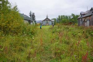 Visitors on Sept. 4, 2021, stroll by the historic chapel and buildings used for classrooms and dormitories that remain standing at Pilgrim Hot Springs. The site was used as an orphanage for Bering Strait-area children who lost their parents to the 1918-19 influenza epidemic. Pilgrim Hot Springs is among the states 11 most endangered historic properties, according to an annual list released by Preservation Alaska. (Yereth Rosen/Alaska Beacon)