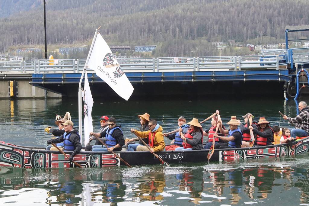 Members of the One People Canoe Society near shore in one of two canoes paddled from Harris Harbor to the Juneau Maritime Festival at Elizabeth Peratrovich Plaza on Saturday morning. (Mark Sabbatini / Juneau Empire)