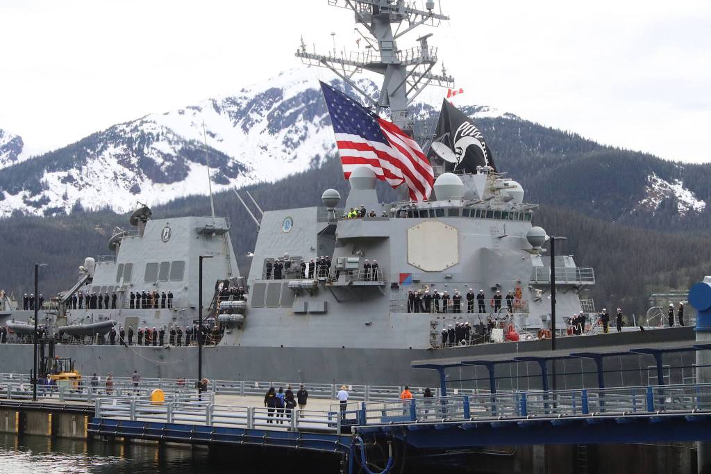 U.S. Navy personnel stand at attention on deck as the USS William P. Lawrence arrives in Juneau on Saturday afternoon. (Mark Sabbatini / Juneau Empire)