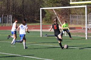 Peyton Wheeler takes a shot for Juneau Douglas High School: Yadaa.at Kalé during Fridays game against Thunder Mountain High School at Adair-Kennedy Field. (Mark Sabbatini / Juneau Empire)