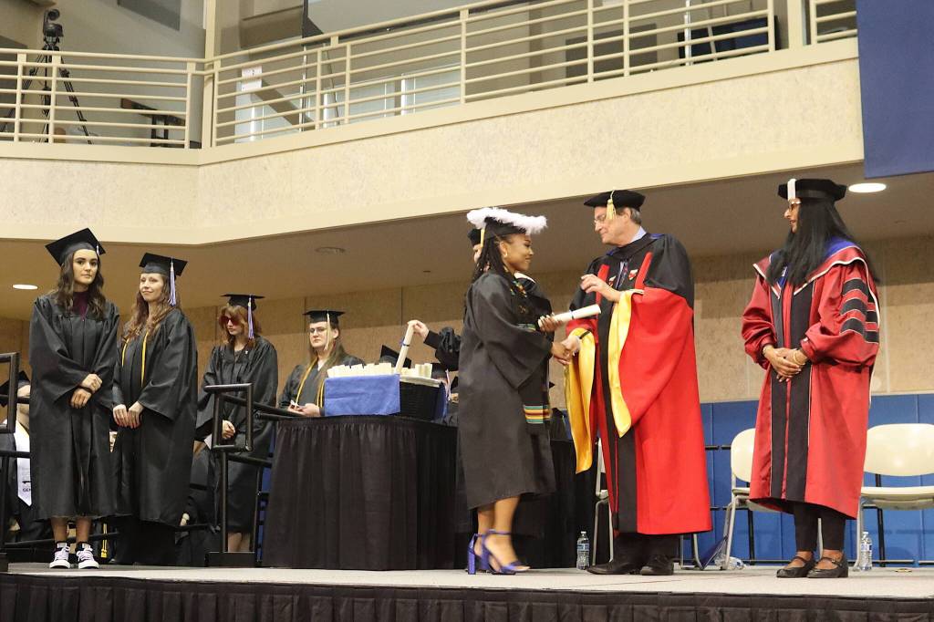 New University of Alaska Southeast graduates receive their degrees and congratulations from Provost Maren Haavig, Vice President Paul Layer and Chancellor Aparna Dileep-Nageswaran Palmer during Sundays commencement ceremony at the UAS Recreation Center. (Mark Sabbatini / Juneau Empire)