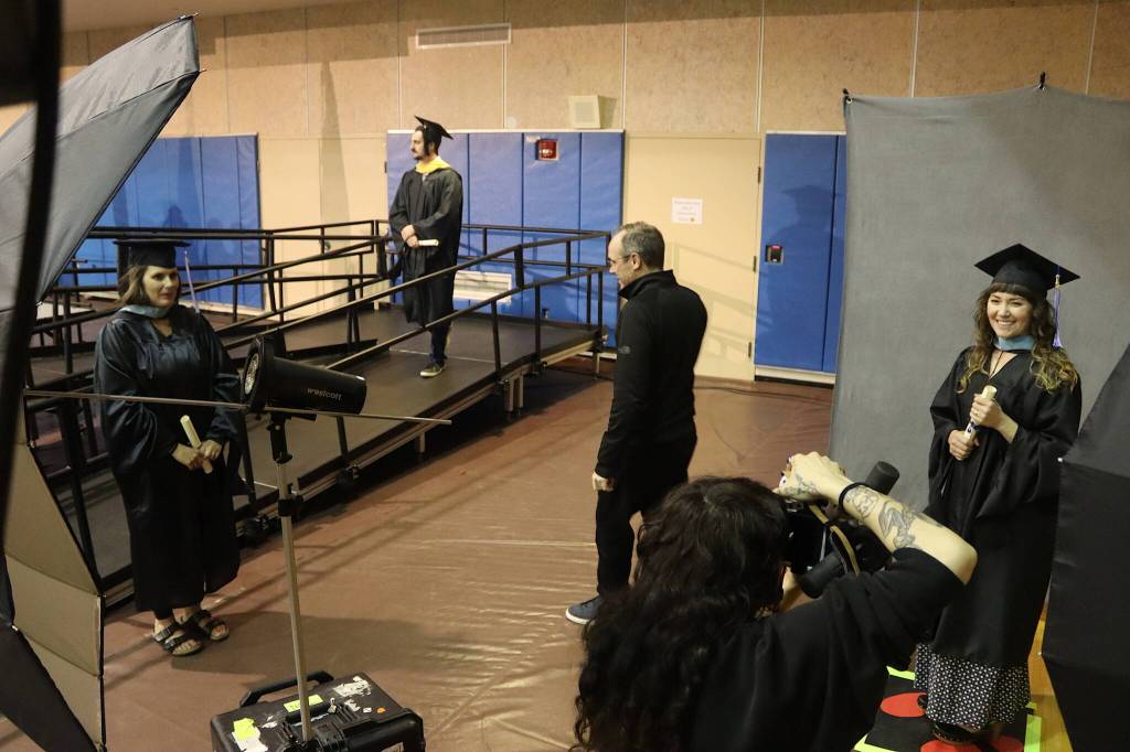 Newly recognized University of Alaska Southeast graduates pose for their official photos after receiving their degrees during Sundays commencement ceremony at the UAS Recreation Center. (Mark Sabbatini / Juneau Empire)