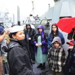 Boatswains Mate Second Class Aliana Valde explains her duties as a deck crew member aboard the USS William P. Lawrence during a tour in Juneau on Sunday. (Mark Sabbatini / Juneau Empire)