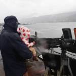 Ripley Wallace and her father, Tyler, aim a .50 caliber heavy machine gun aboard the U.S. Navys USS William P. Lawrence during a tour Sunday. (Mark Sabbatini / Juneau Empire)
