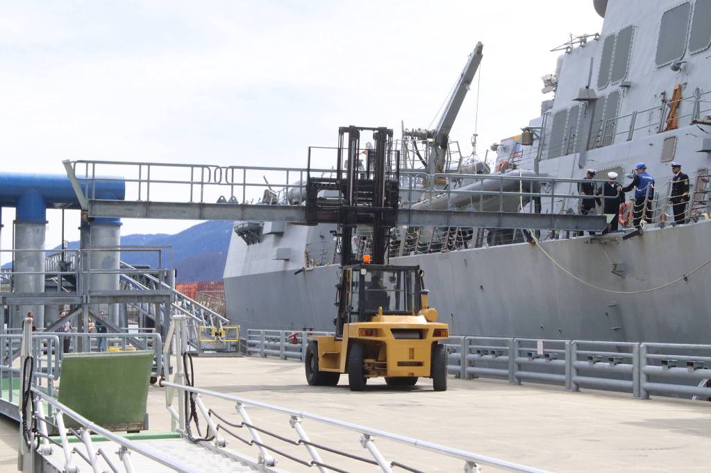 A forklift driven by a city Docks and Harbors worker places a gangway in place for the USS William P. Lawrence after the U.S. Navy destroyer arrives in Juneau on Saturday afternoon. (Mark Sabbatini / Juneau Empire)