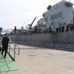 Officers and other crew aboard the USS William P. Lawrence prepare to disembark after the U.S. Navy destroyer docks in Juneau on Saturday afternoon. (Mark Sabbatini / Juneau Empire)