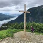 Hiker Linda Kruger reaches Father Browns Cross on Mount Roberts in this July 2020 photo. Kruger has organized the annual trail race to the cross for the past ten years. This years race is scheduled for Saturday, July 6, although the cross is no longer there. (Photo courtesy Jeff Gnass)