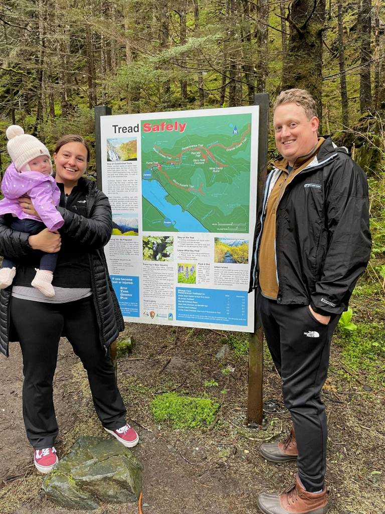 Maddy McRaven, Kevin Riley and their five-month-old daughter Lily, all visiting from St. Louis, Missouri, stand beside the Mount Roberts Trailhead sign on Basin Road on Wednesday. The couple had arrived 12 hours earlier for a short visit to Juneau. On the recommendation of a fellow airline passenger, they had already hiked the flume trail which easily accommodated Lilys stroller. (Laurie Craig/Juneau Empire)