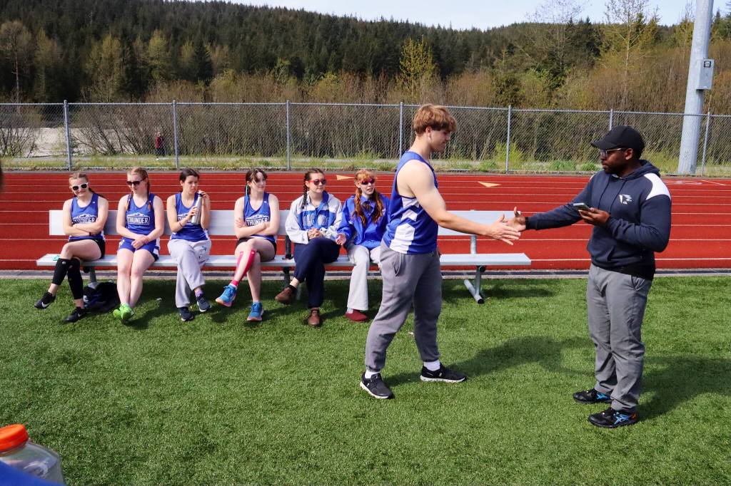Thunder Mountain High School track and field coach Dwayne Duskin Jr. congratulates seniors during the Capital Invitational Track and Field Meet on Saturday at TMHS. This is the final year TMHS will have a team due to all students in grades 9-12 being consolidated into Juneau-Douglas High School: Yadaa.at Kalé starting next school year. (Mark Sabbatini / Juneau Empire)