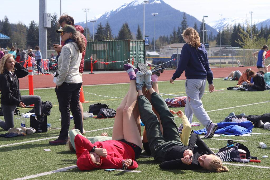 Juneau-Douglas High School: Yadaa.at Kalé students stretch and rest following their participation in the Capital Invitational Track and Field Meet on Saturday at Thunder Mountain High School. (Mark Sabbatini / Juneau Empire)