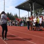 Family, coaches and classmates congratulate the 11 seniors on Juneau-Douglas High School: Yadaa.at Kalé girls soccer team before its home finale against Ketchikan High School on Saturday against Adair-Kennedy Field. (Mark Sabbatini / Juneau Empire)