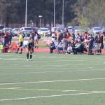 Finley Sullivan (right), a senior forward who broke her finger in practice a month ago, performs a kickoff to Ruby Rivas (#9), a senior midfielder who tore an anterior cruciate ligament in January, during the final home game of the season for the Juneau-Douglas High School: Yadaa.at Kalé girls soccer team Saturday at Adair-Kennedy Field. Both players came out of the game moments later during an intentional stoppage in play. (Mark Sabbatini / Juneau Empire)