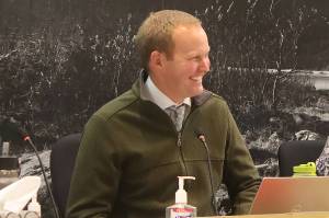 Municipal Attorney Robert Palmer reacts to praise for his service from Juneau Assembly members after his resignation was announced during an Assembly meeting Monday night. (Mark Sabbatini / Juneau Empire)
