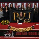 Juneau-Douglas High School: Yadaa.at Kalé senior Mila Hargrave, shown with JDHS softball team members, signed a national letter of intent on Monday at the George Houston Gymnasium to attend Pacific Lutheran University and play softball for the Lutes. (Klas Stolpe / For the Juneau Empire)