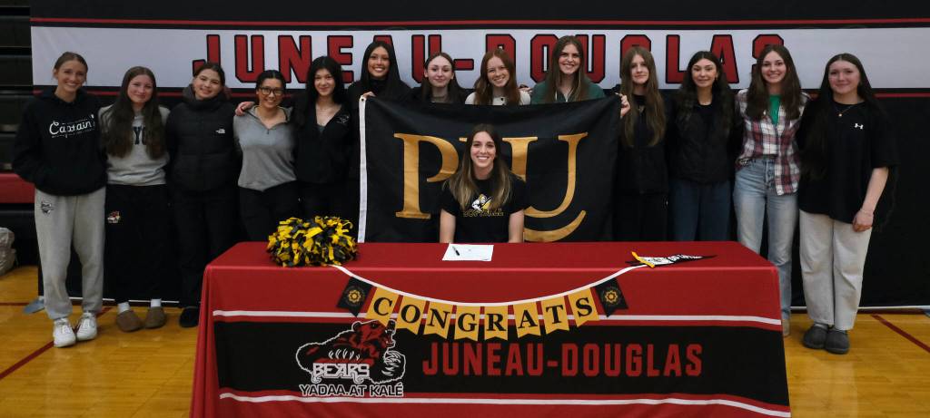 Juneau-Douglas High School: Yadaa.at Kalé senior Mila Hargrave, shown with JDHS softball team members, signed a national letter of intent on Monday at the George Houston Gymnasium to attend Pacific Lutheran University and play softball for the Lutes. (Klas Stolpe / For the Juneau Empire)