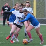 Juneau-Douglas High School: Yadaa.at Kalés Parker Boman (8) and Thunder Mountain High Schools Piper Blackgoat go for a ball during the Falcons final home game Monday at Falcons Field. (Klas Stolpe / For the Juneau Empire)