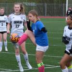 Thunder Mountain High School senior Zoey Moore controls a ball betweenJuneau-Douglas High School: Yadaa.at Kalé freshman Alyssa Travis (17) and senior Nikki King during the TM girls soccer senior night Monday at Falcons Field. (Klas Stolpe for the Juneau Empire)(Klas Stolpe / For the Juneau Empire)