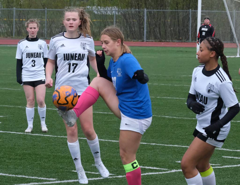 Thunder Mountain High School senior Zoey Moore controls a ball betweenJuneau-Douglas High School: Yadaa.at Kalé freshman Alyssa Travis (17) and senior Nikki King during the TM girls soccer senior night Monday at Falcons Field. (Klas Stolpe for the Juneau Empire)(Klas Stolpe / For the Juneau Empire)
