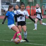 Thunder Mountain High School senior Adella Dihle (38) and Juneau-Douglas High School: Yadaa.at Kalé senior Cadence Plummer (12) work for a ball during the Falcons final home game Monday at Falcons Field. (Klas Stolpe / For the Juneau Empire)