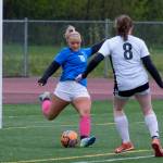 Thunder Mountain High Schools Miley Andrews (16) clears a ball past JDHS Crimson Bears Parker Boman (8) during the Falcons final home game Monday at Falcons Field. (Klas Stolpe / For the Juneau Empire)