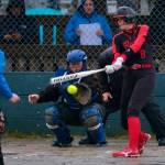 Thunder Mountain High School senior catcher Kara Strong awaits a pitch as Juneau-Douglas High School: Yadaa.at Kalé senior batter Mila Hargrave swings during the Falcons 10-9 win over the Crimson Bears on Tuesday at Dimond Park Fields. (Klas Stolpe, For the Juneau Empire)