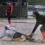 Thunder Mountain High School senior Jenna Dobson is tagged out on a steal attempt at third base by Juneau-Douglas High School: Yadaa.at Kalé senior Kiya Yadao during the Falcons 10-9 win over the Crimson Bears on Tuesday at Dimond Park Fields. (Klas Stolpe, For the Juneau Empire)