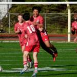 Juneau-Douglas High School: Yadaa.at Kalé freshman Sam Mazon (center) celebrates his goal with juniors Ryan Thibodeau (12), Kai Ciambor, Kellen Chester (10), Ahmir Parker (9) and senior Sonny Monsef (30) during the Crimson Bears 4-2 win over the Kings at Adair-Kennedy Field on Friday. (Klas Stolpe / For the Juneau Empire)