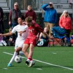 Juneau-Douglas High School: Yadaa.at Kalé senior Kai Ciambor strikes under pressure from Ketchikans RJ Cadiente (6) during the Crimson Bears 4-2 win over the Kings at the Adair Kennedy pitch on Friday. (Klas Stolpe / For the Juneau Empire)