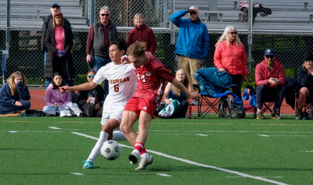 Juneau-Douglas High School: Yadaa.at Kalé senior Kai Ciambor strikes under pressure from Ketchikans RJ Cadiente (6) during the Crimson Bears 4-2 win over the Kings at the Adair Kennedy pitch on Friday. (Klas Stolpe / For the Juneau Empire)