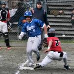 Thunder Mountain High Schools Hayden Aube races a throw to Juneau-Douglas High School: Yadaa.at Kalé first baseman Riley Fick. (Klas Stolpe / For the Juneau Empire)
