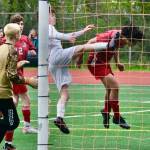 Juneau-Douglas High School: Yadaa.at Kalé senior Sonny Monsef (30) heads in a goal against Ketchikan during the Crimson Bears 2-0 title clinching win over the Kings at Adair-Kennedy Field on Saturday. (Klas Stolpe / For the Juneau Empire)